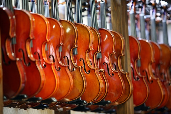 violins hanging on living room wall